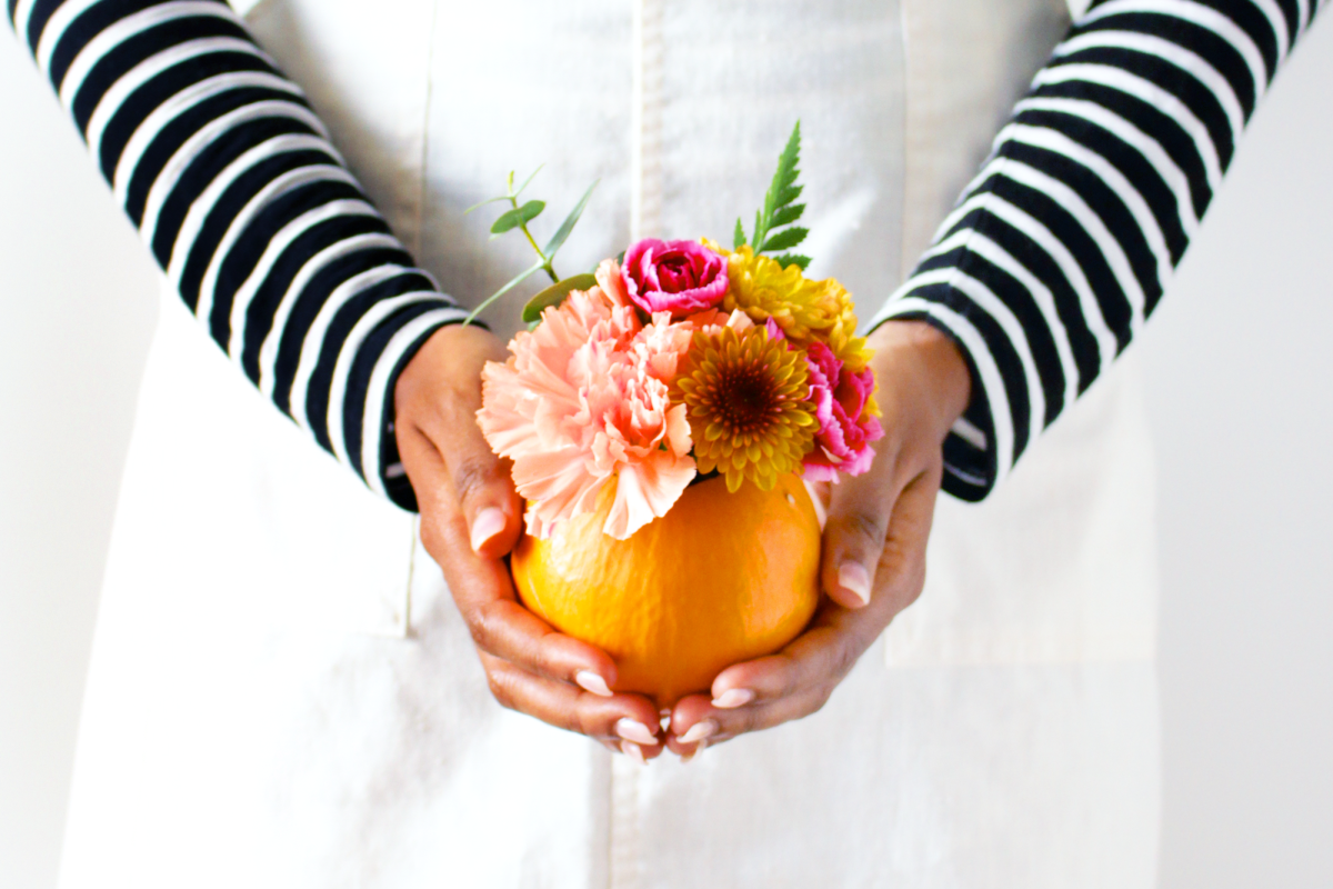 As soon as I saw mini pumpkins at the grocery store, I knew I had to make a DIY with them! I'm kinda obsessed with fresh flowers and miniature things so DIY mini pumpkin florals are pretty much the perfect combo. Now I don't usually decorate in orange like ever but I think it works really well in small doses like this. Right? In this case, the warm, small pop of orange adds a really cheerful touch that makes us love sweater weather even more!